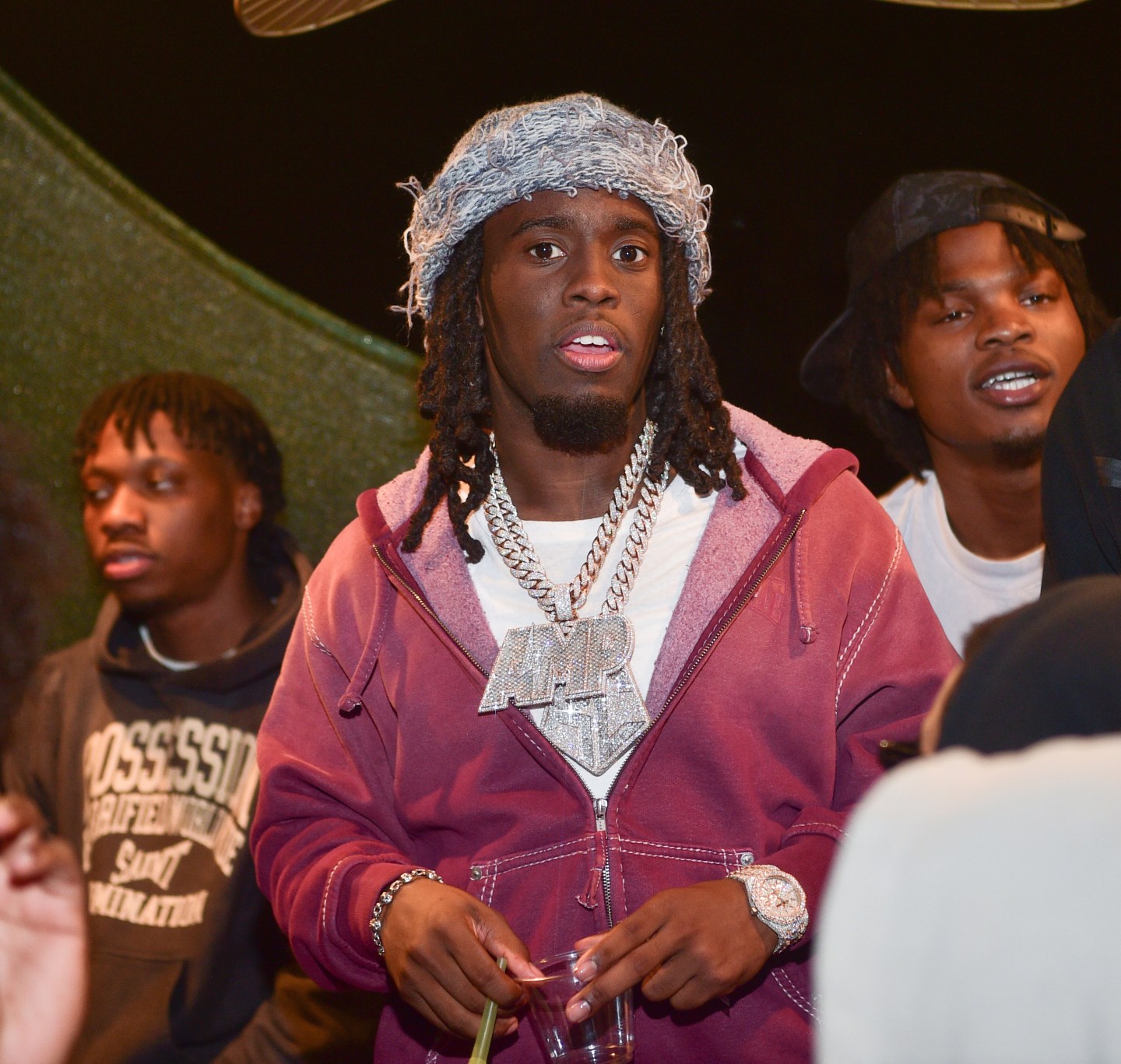 Kai Cenat in a pink sweatshirt