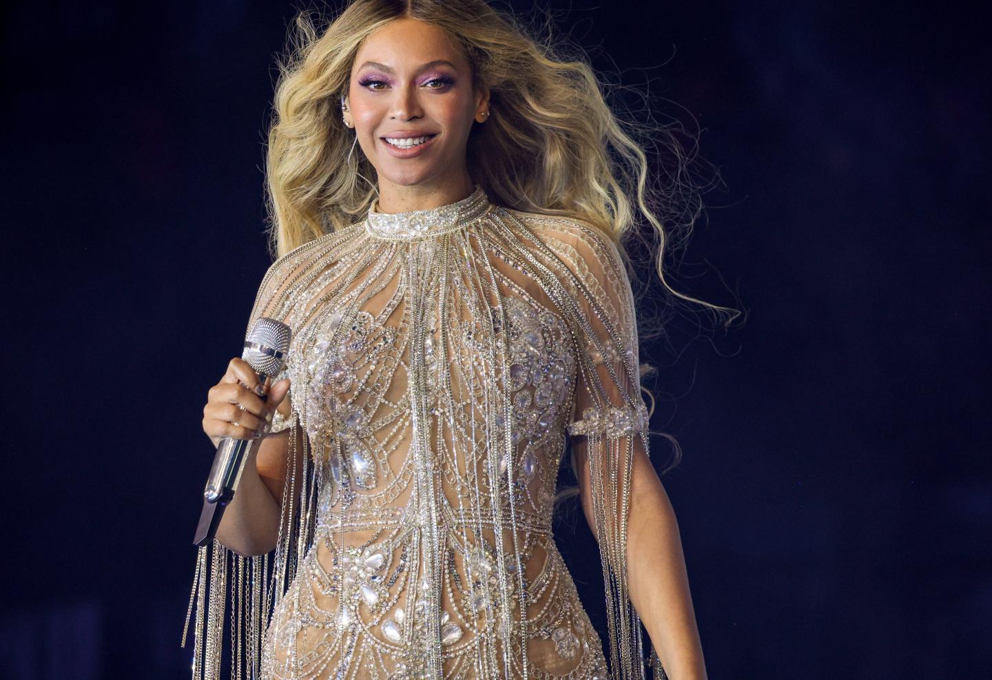 Beyoncé onstage holding a mic.