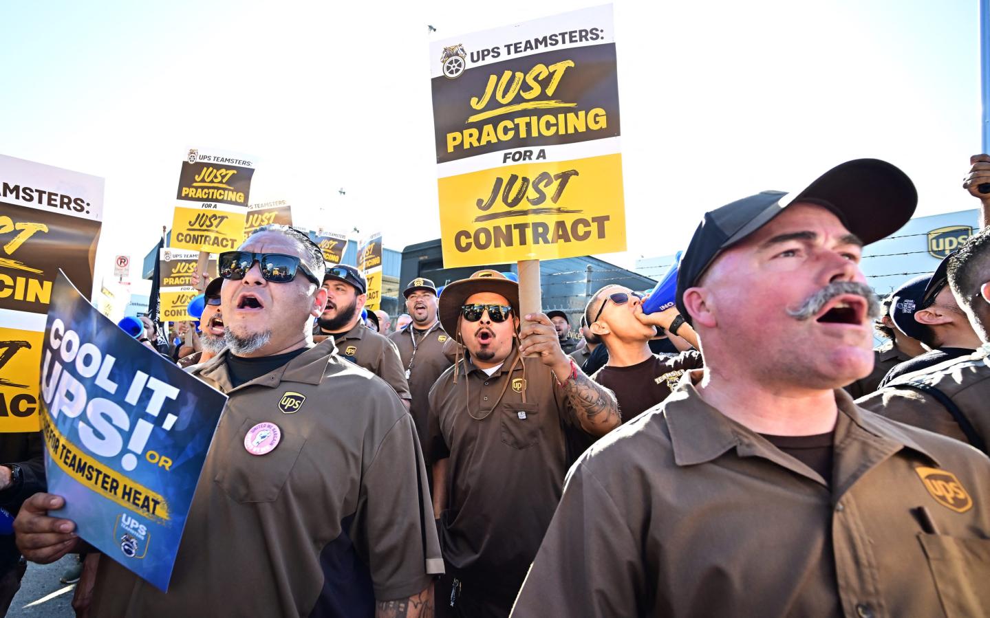 Teamsters hold signs at a rally during contract negotiations