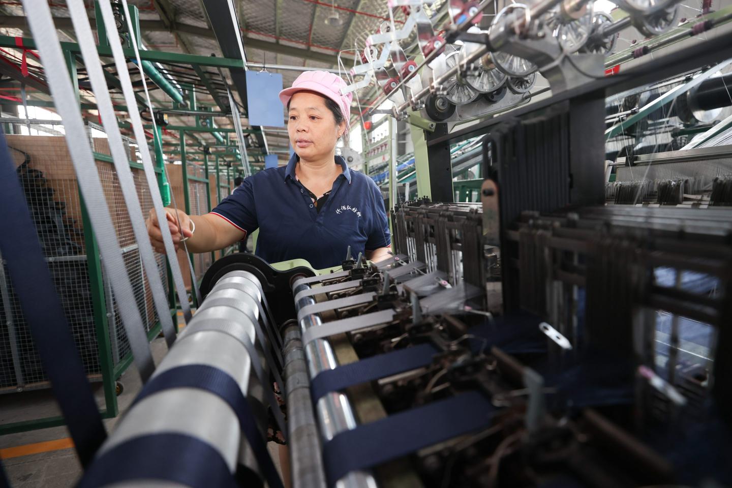 A worker produces textile products for export at a workshop of a company in Lianyungang city, Jiangsu province, China, August 9, 2023. 