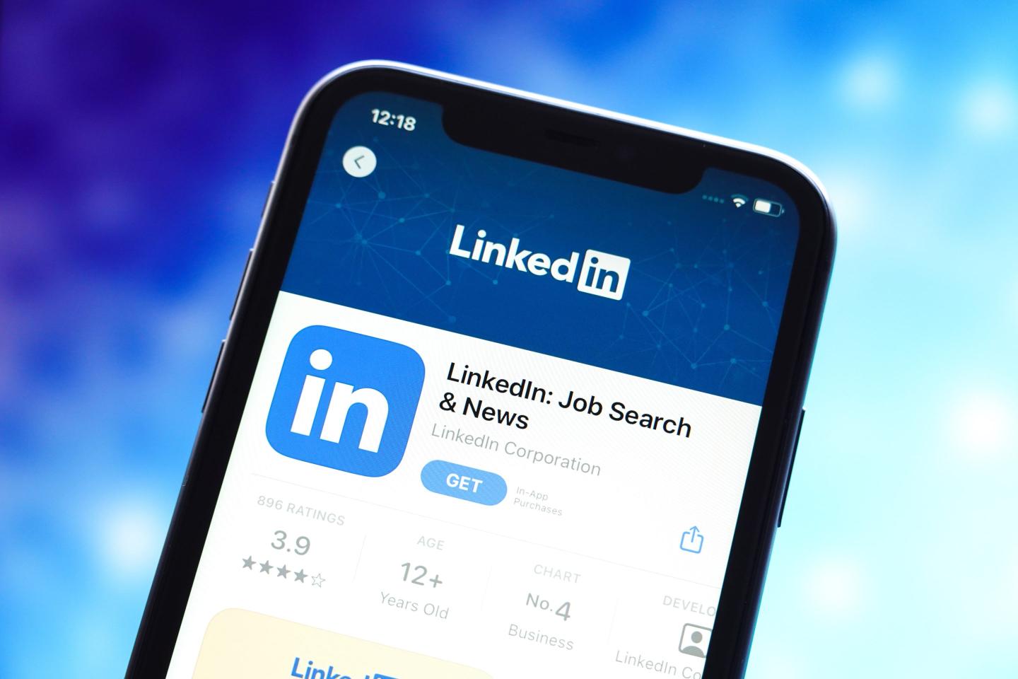 In this photo illustration, the LinkedIn logo is displayed in the Apple App Store on a smartphone screen.