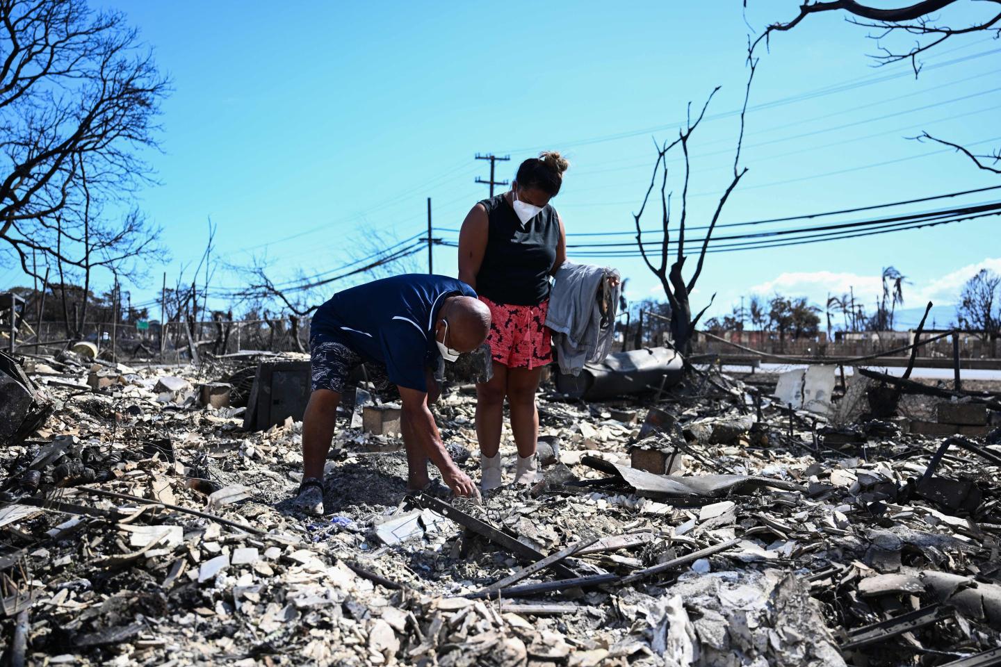 Hawaiian residents searching through the rubble of homes destroyed by fire in western Maui, August 11, 2023.