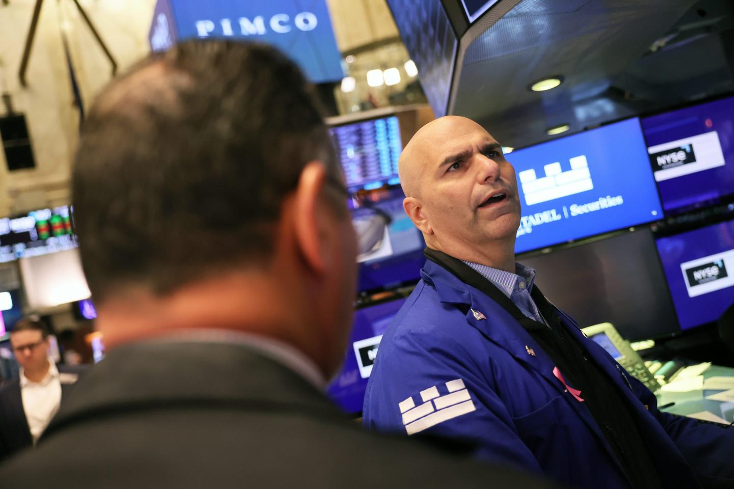 Traders work on the floor of the New York Stock Exchange during morning trading on August 10, 2023, in New York City.