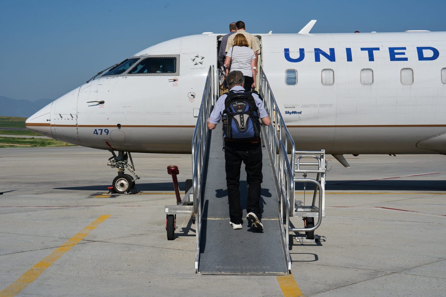 Passengers board a Bombardier CRJ200 jet, operated by United Airlines
