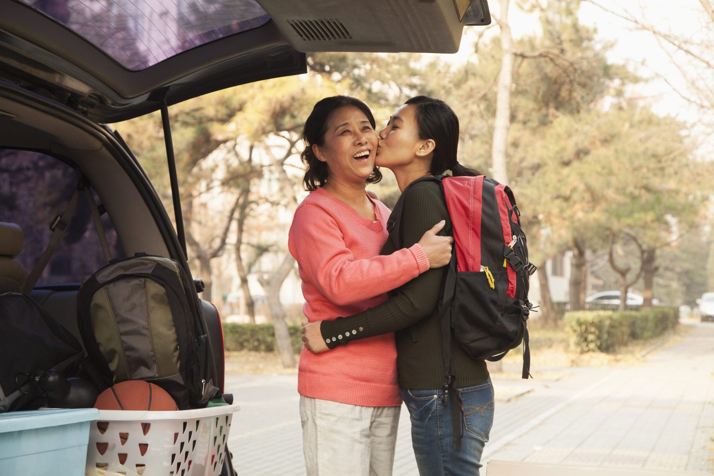 A mother and daughter embracing on a college campus