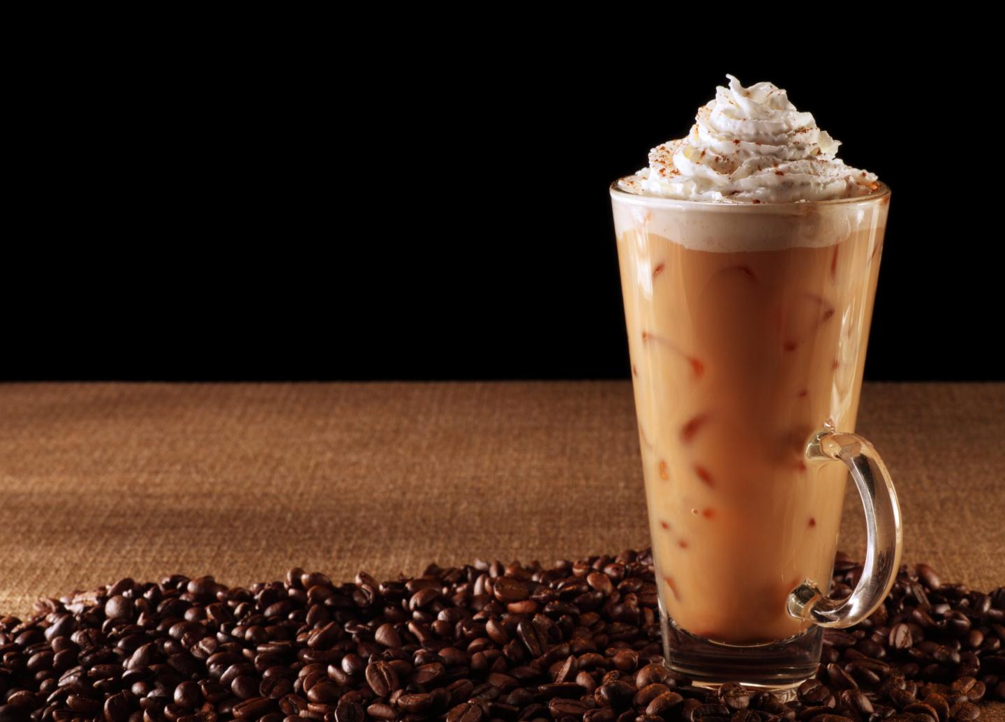 An iced pumpkin spice latte with whipped cream