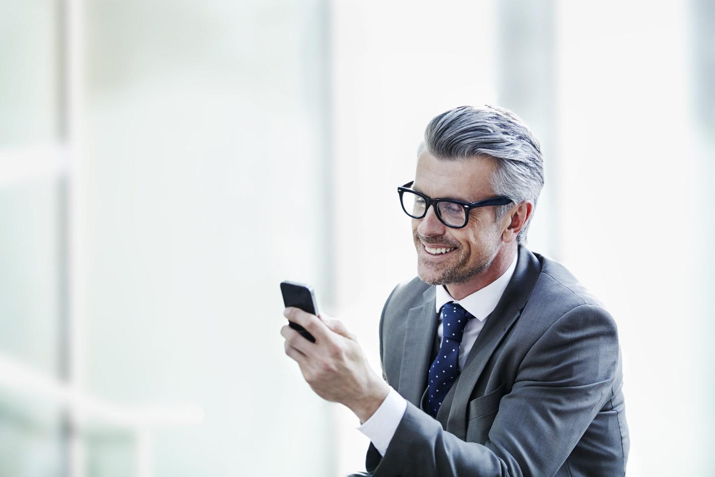A businessman looking at his smartphone