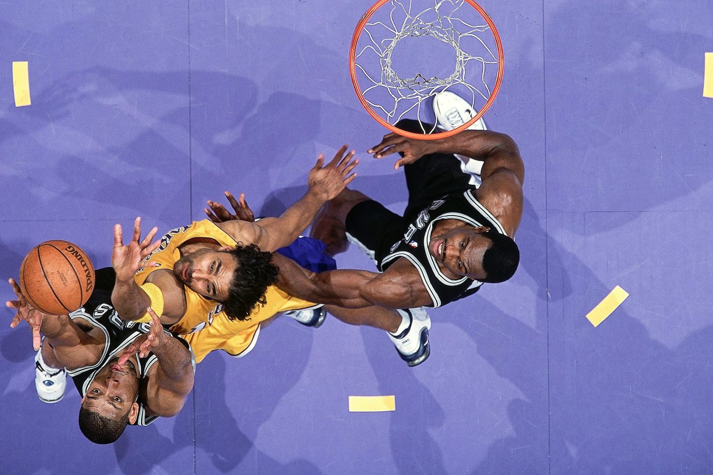 San Antonio Spurs Tim Duncan (21) and David Robinson (50) in action vs Los Angeles Lakers Rick Fox (17) at the NBA playoffs in 2001.