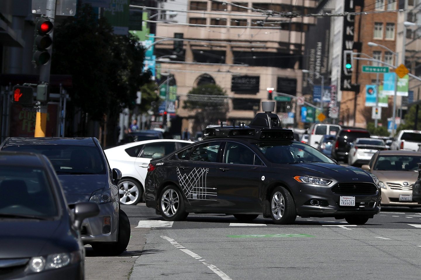 An Uber self-driving car drives down 5th Street in San Francisco.