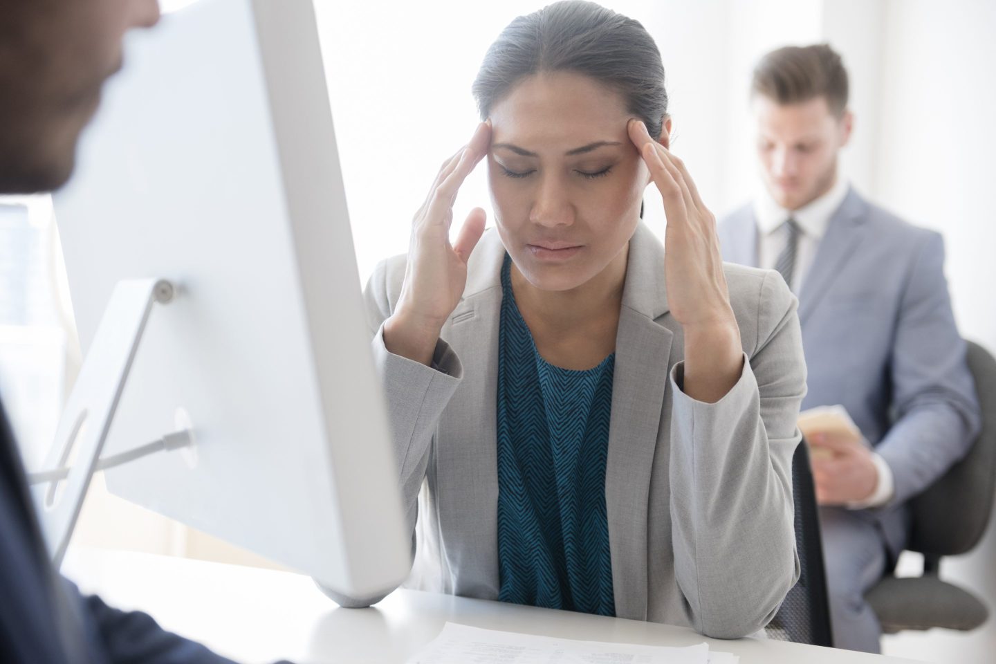 An annoyed woman sitting at her office desk