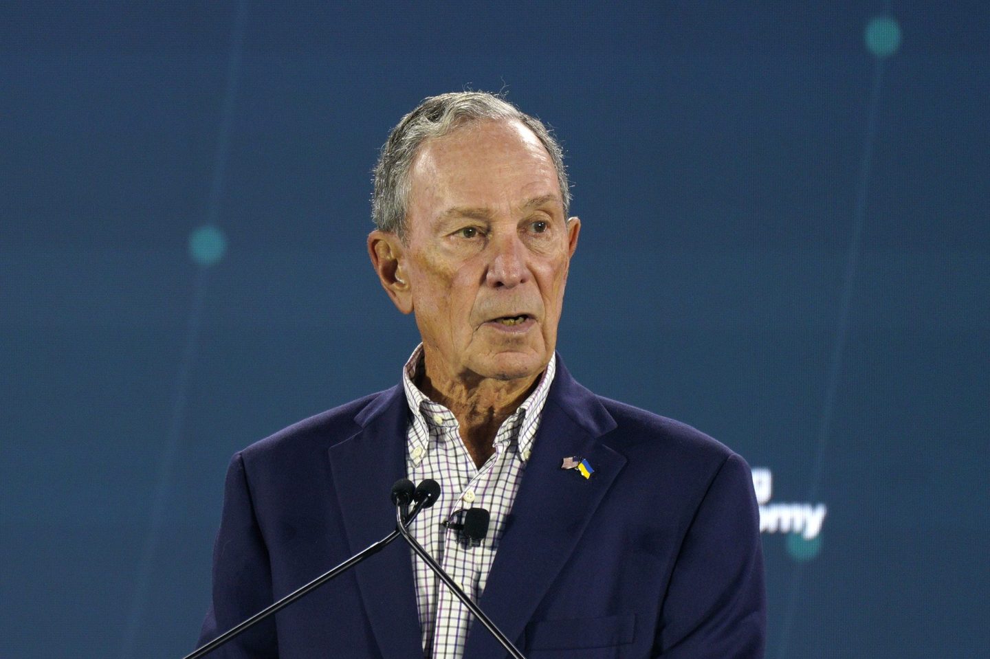 Michael Bloomberg speaks from a podium.