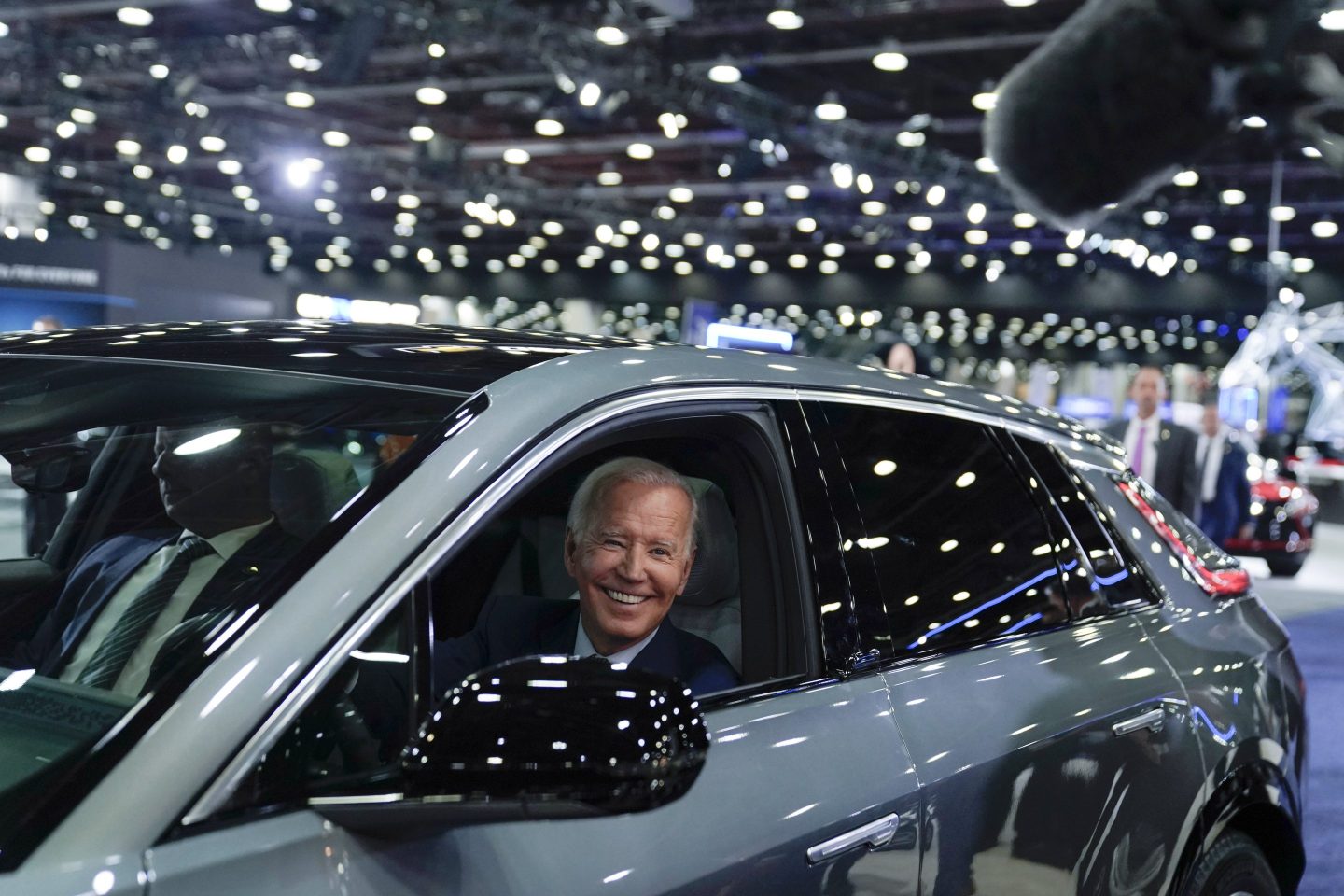 President Joe Biden drives a Cadillac Lyriq through the showroom during a tour at the Detroit Auto Show, on Sept. 14, 2022, in Detroit.