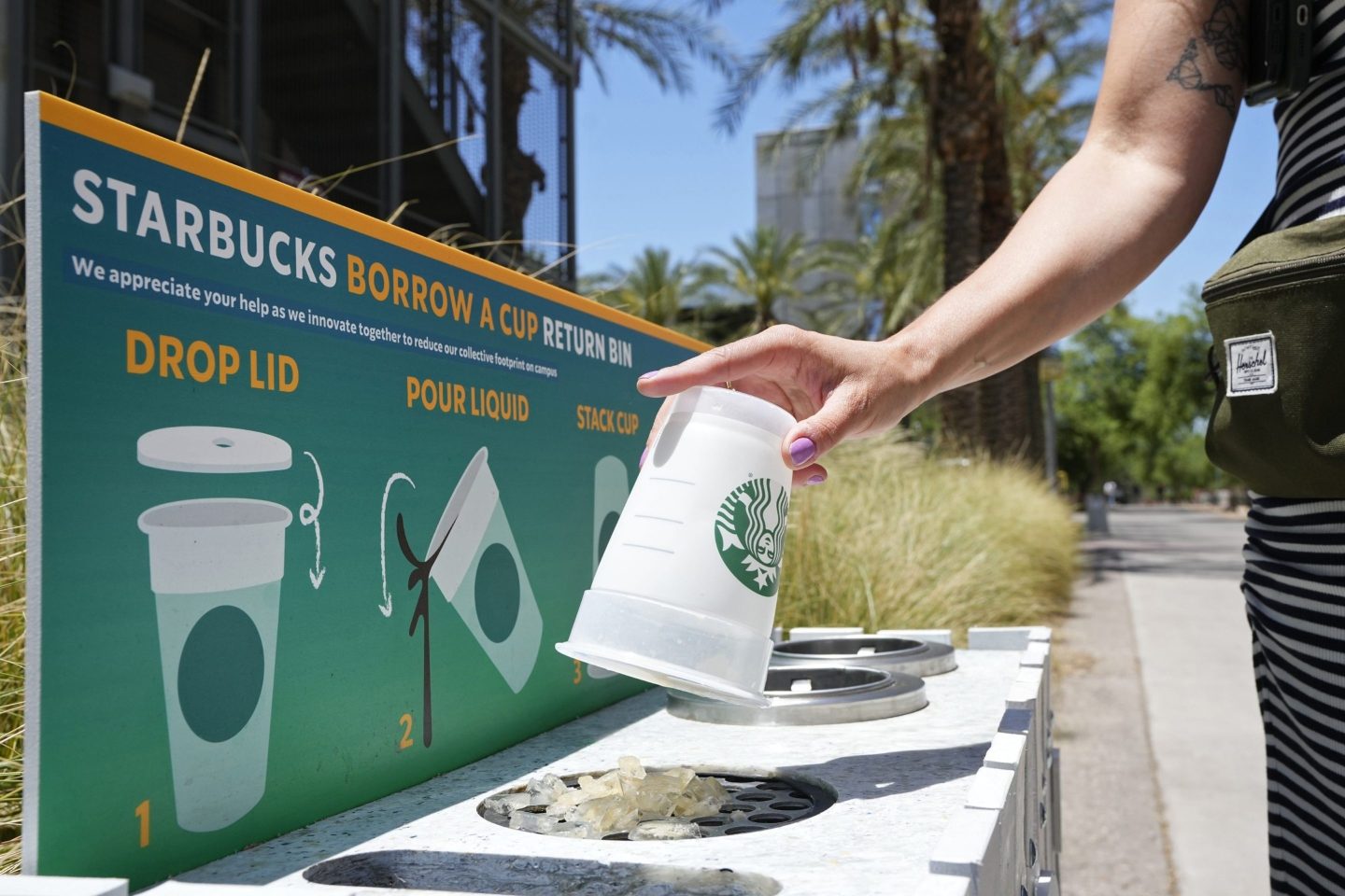 A reusable cup is returned to a borrow a cup return bin at an Arizona State University Starbucks shop on June 7, 2023, in Tempe, Ariz.
