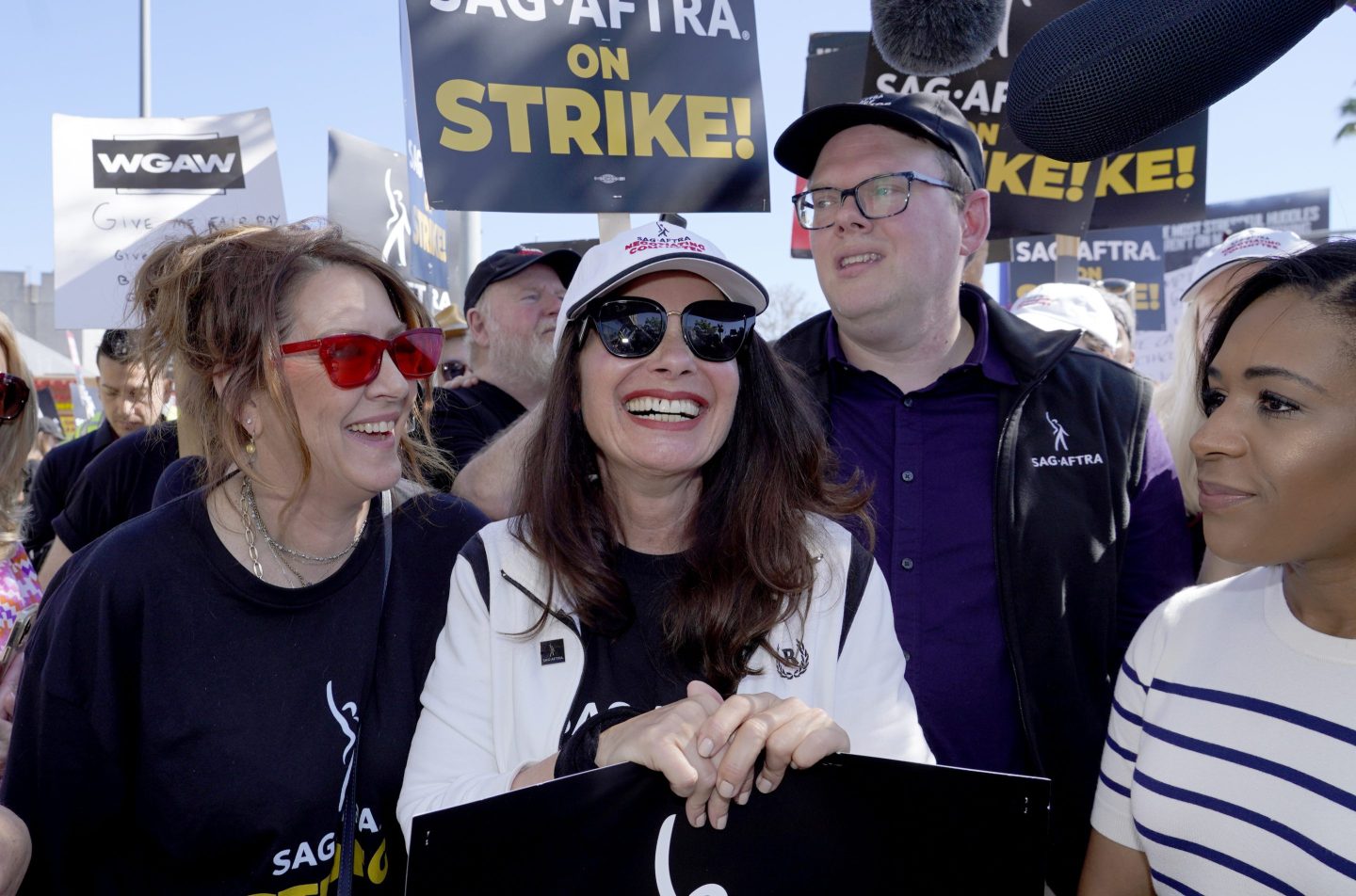 Actor Joely Fisher, from left, SAG-AFTRA president Fran Drescher, and Duncan Crabtree-Ireland, SAG-AFTRA national executive director and chief negotiator, take part in a strike rally outside Netflix studio in Los Angeles on July 14, 2023.