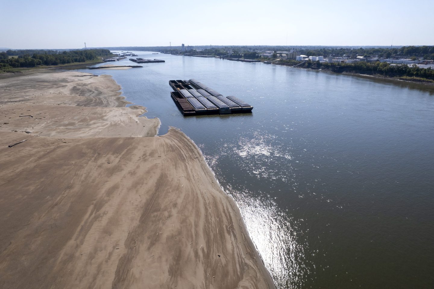 Barges float in the Mississippi River as a portion of the riverbed is exposed, Friday, Sept. 15, 2023, in St. Louis.