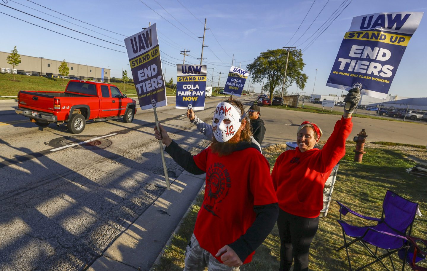 UAW members including Scott Kralovic, wearing a mask, work the picket line during a strike on Sept. 19, 2023, at the Stellantis Toledo Assembly Complex where Jeeps are made in Toledo, Ohio.