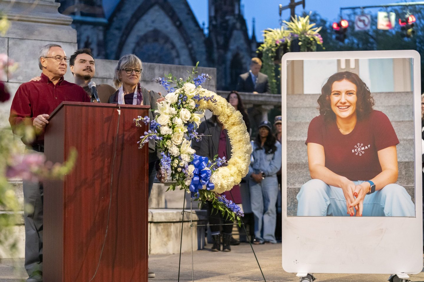 Frank LaPere, Nico LaPere and Caroline Frank, the family of Pava LaPere, founder of tech startup EcoMap Technologies, speak during a vigil on Sept. 27, 2023, in Baltimore.