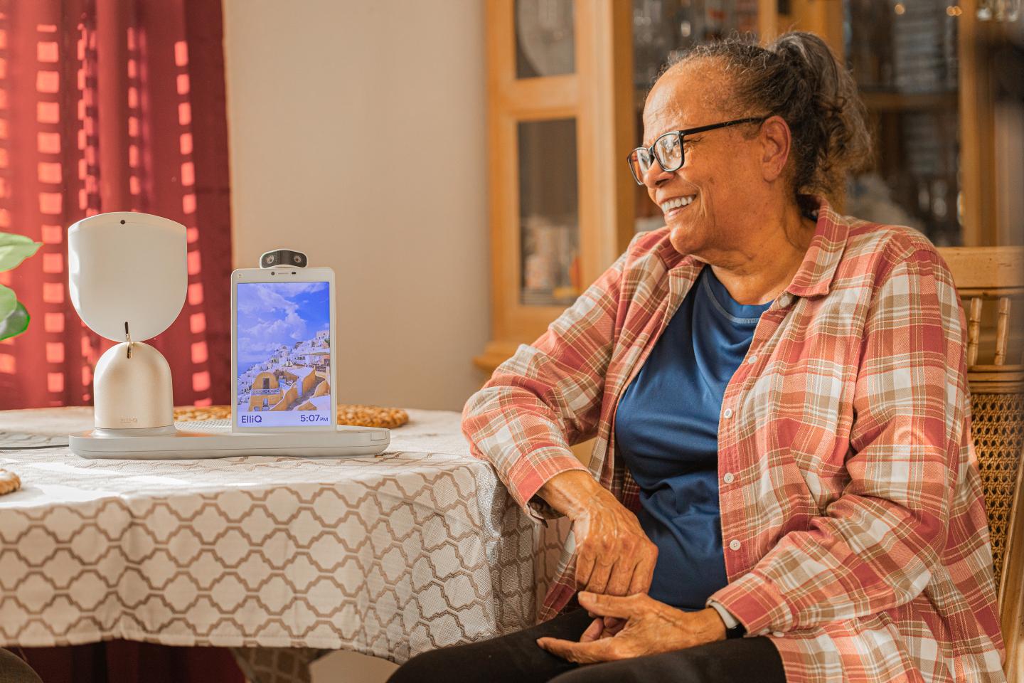 A woman using a 'companion robot' from Intuition Robotics.