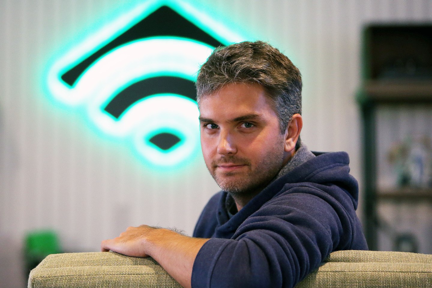 man in sweatshirt stares at the camera