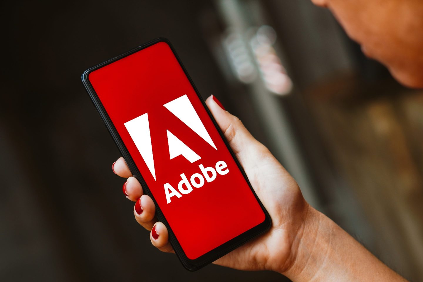 In this photo illustration, the Adobe Inc. logo is displayed on a smartphone screen.
