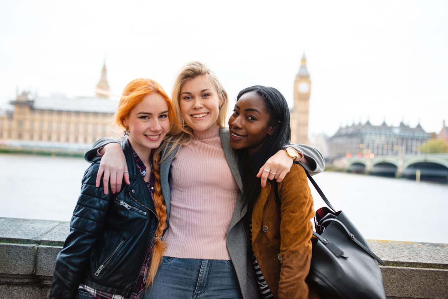 three women standing in front of big ben