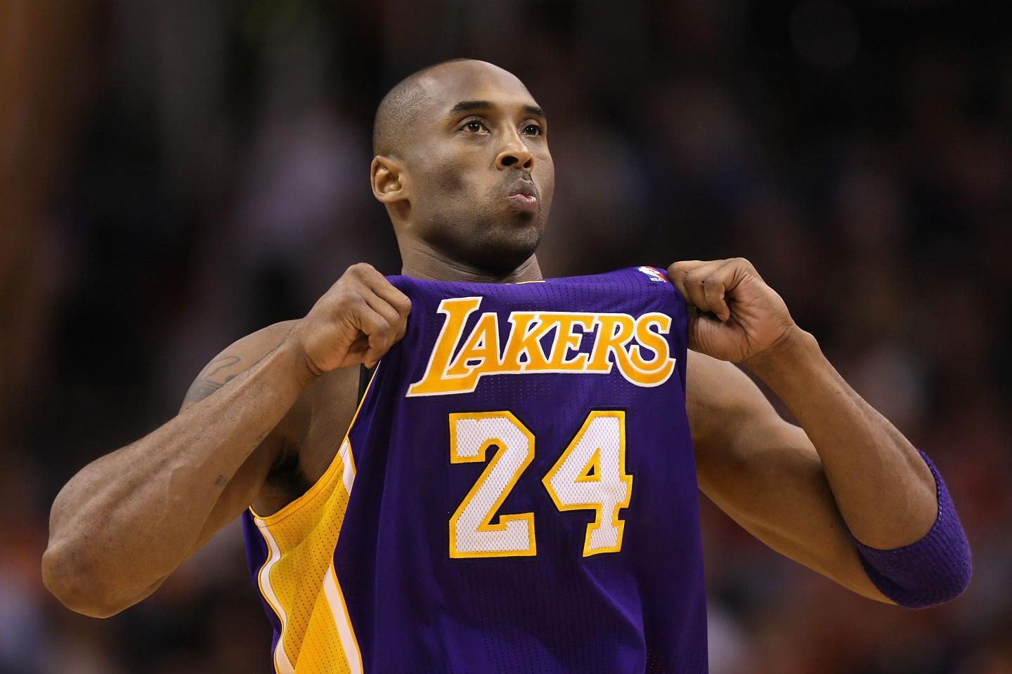 Kobe Bryant #24 of the Los Angeles Lakers adjusts his jersey during the NBA game against the Phoenix Suns at US Airways Center on February 19, 2012 in Phoenix, Arizona.