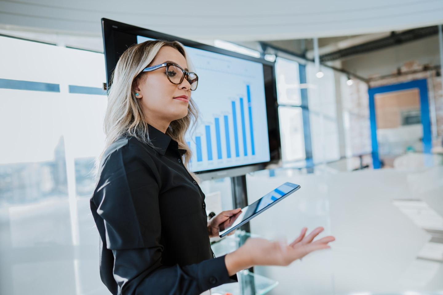woman in professional clothing leads a meeting