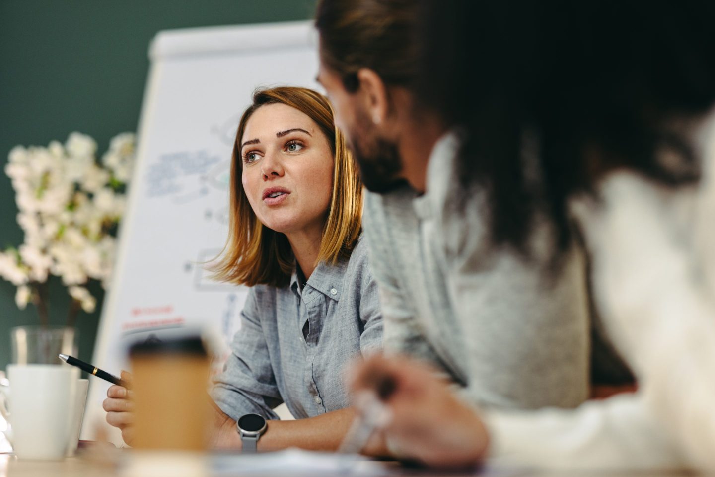two female business professionals talking at a table