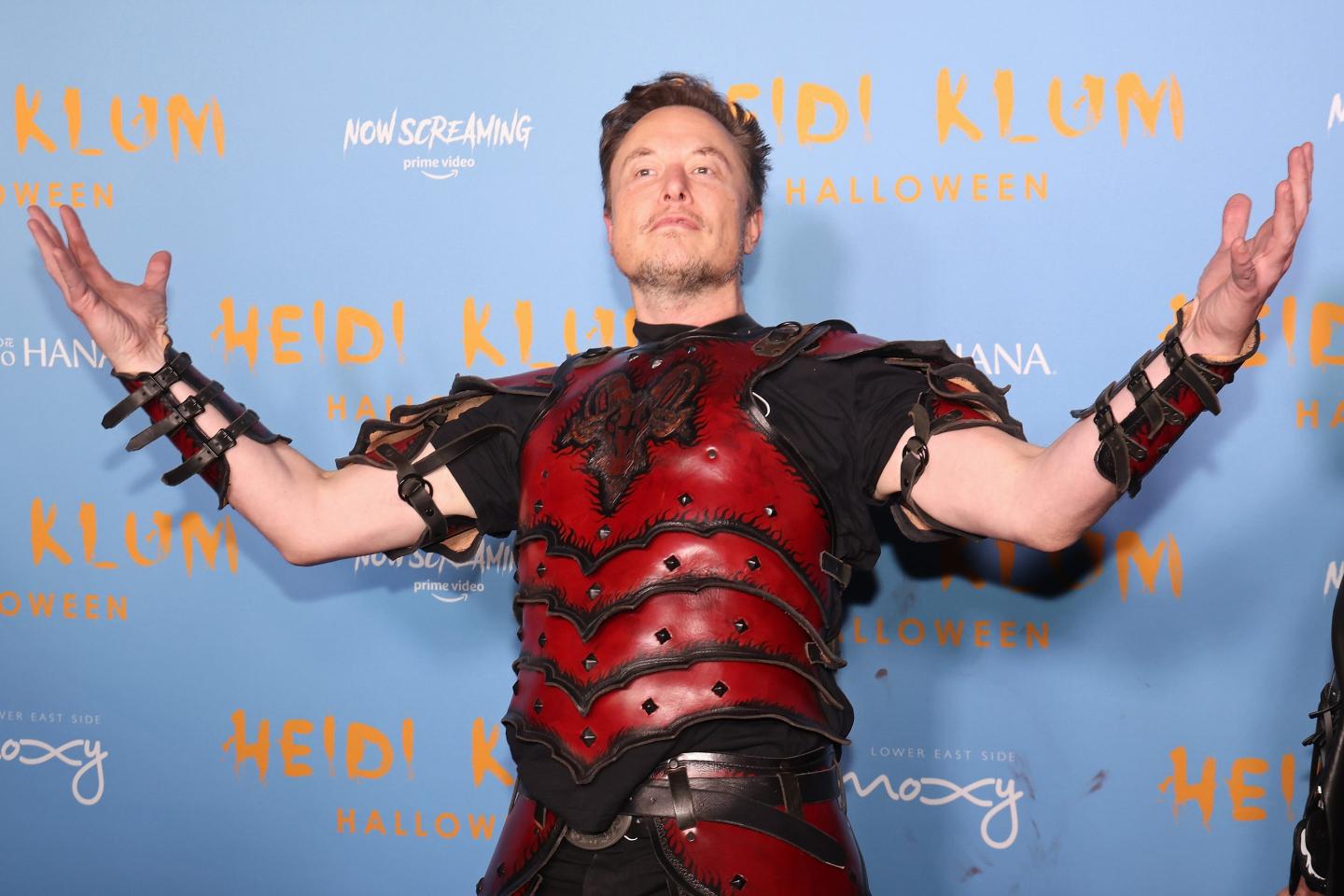 Elon Musk at Heidi Klum's Halloween Party dressed in red armor.