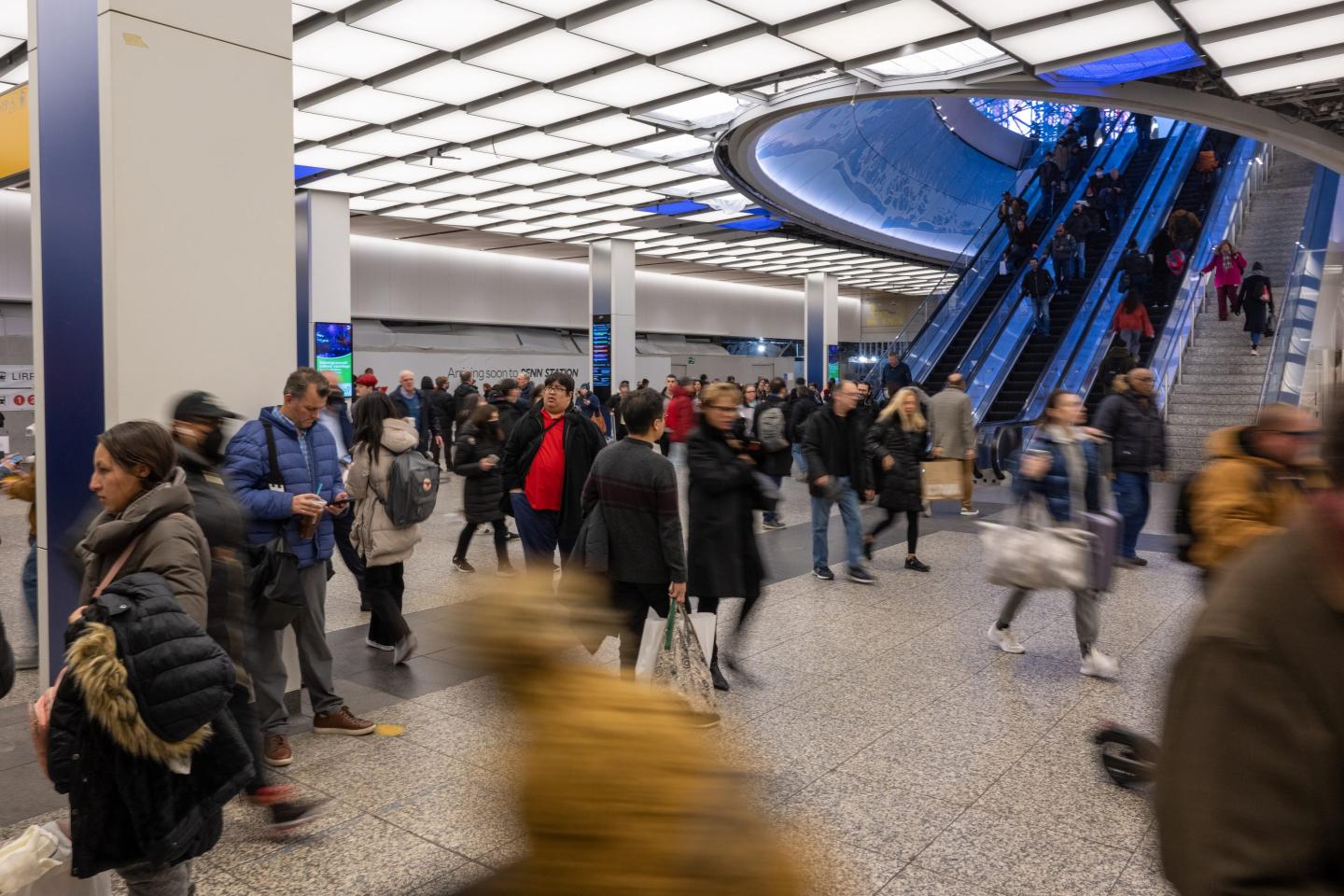Crowds of people move through parts of the newly renovated Penn Station