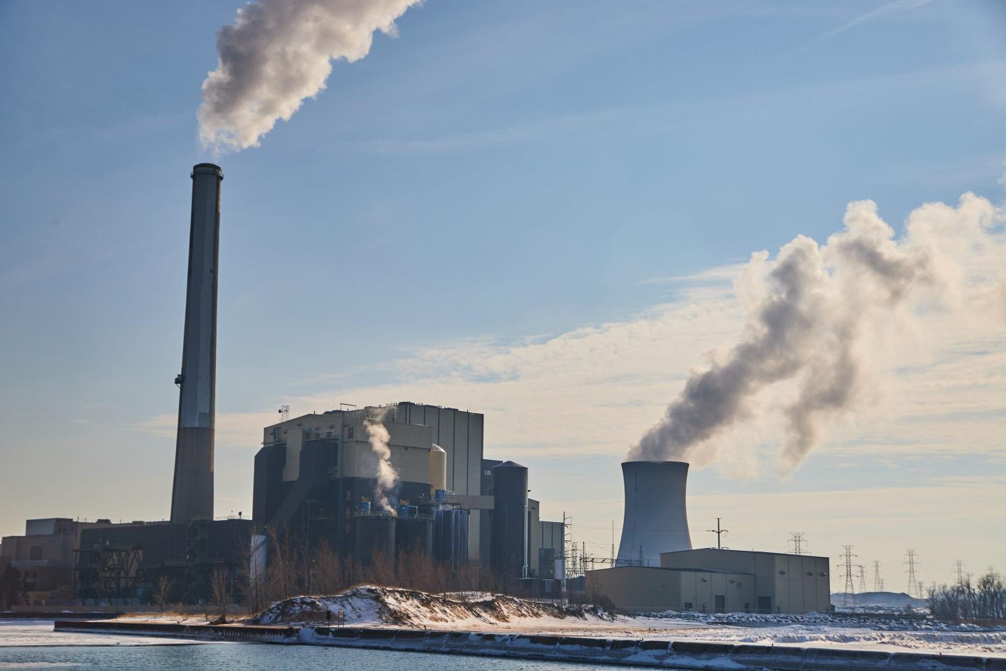 Factory manufacturing plant with solos and smog into sky