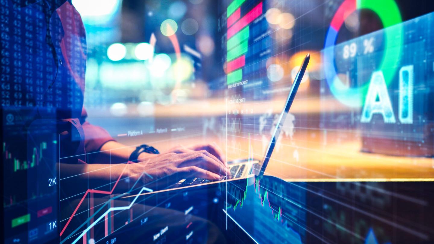 man using a laptop with data animated overlays