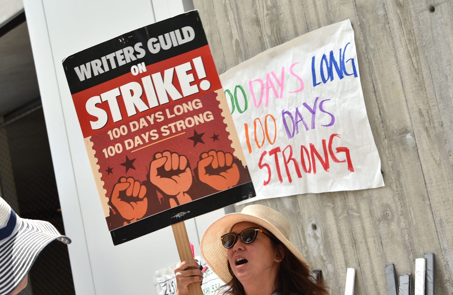 Members of the Writers Guild of America (WGA) walk the picket line on the 100th day of strike outside of Fox Studios in Los Angeles, on August 9, 2023.