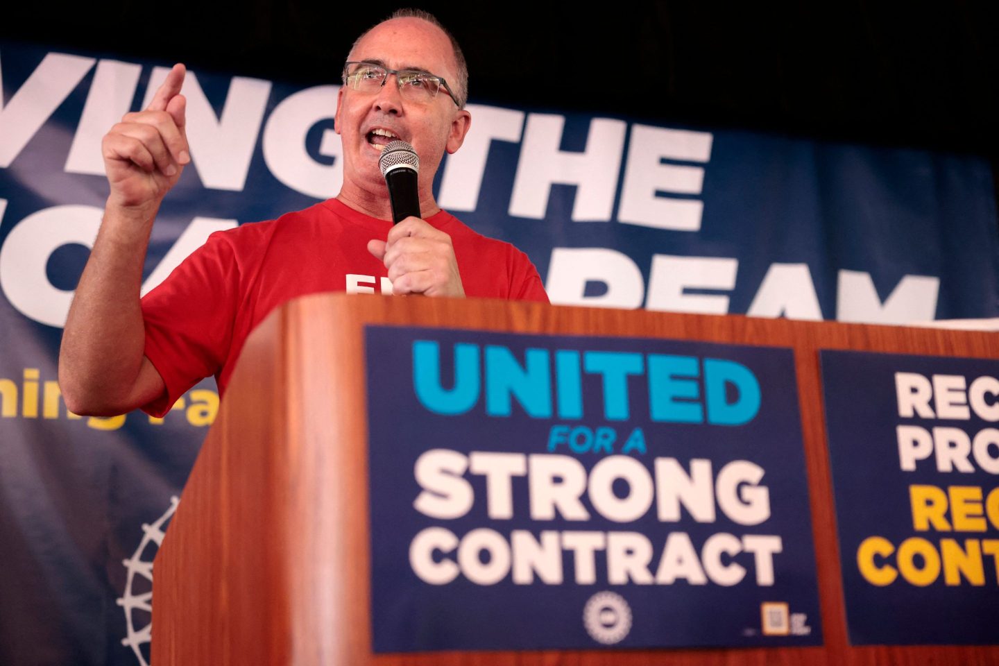 UAW president Shawn Fain, who was elected on a vow to be more aggressive with carmakers, speaks at a rally less than a month before the Big Three's contract with the union expires.