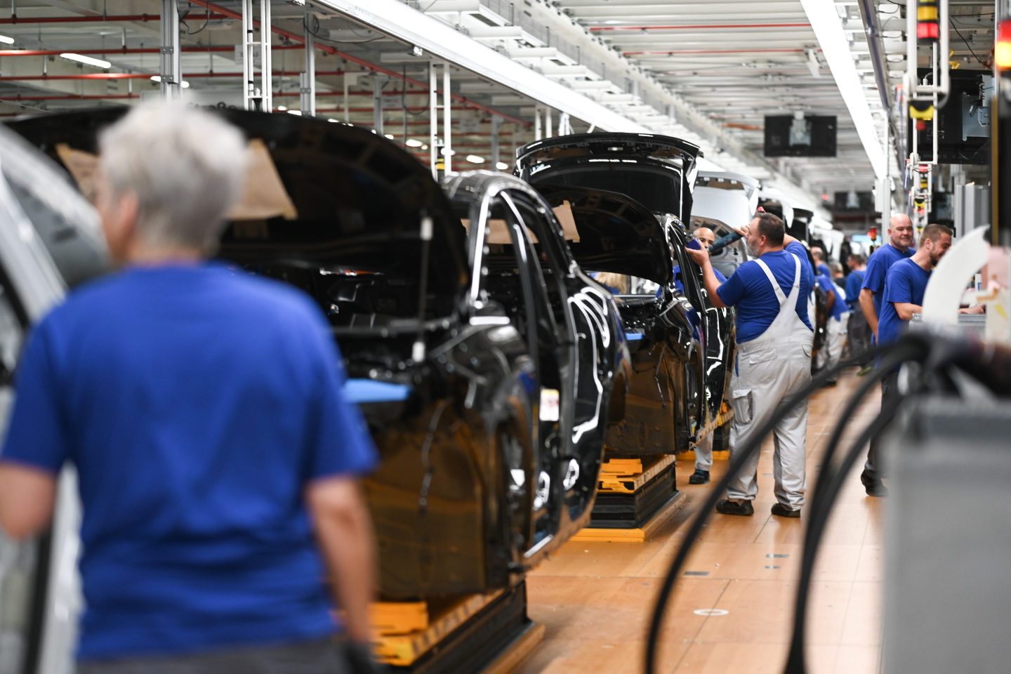 A production line working on a series of electric cars in a manufacturing factory