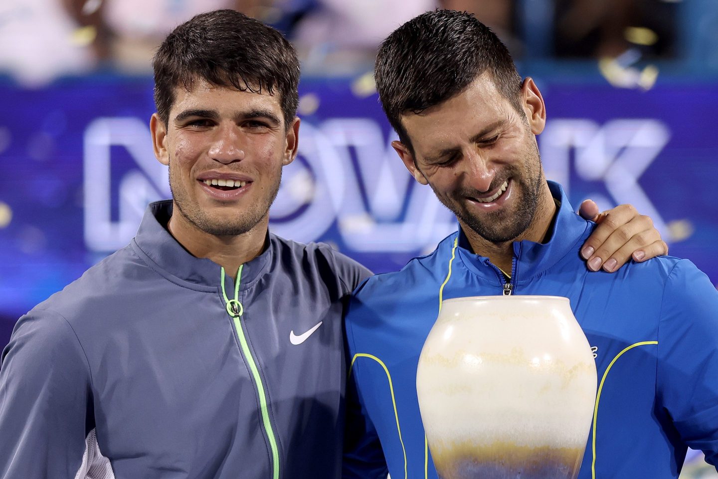 Carlos Alcaraz and Novak Djokovic pose together with their trophies after the Cinncinati Masters.