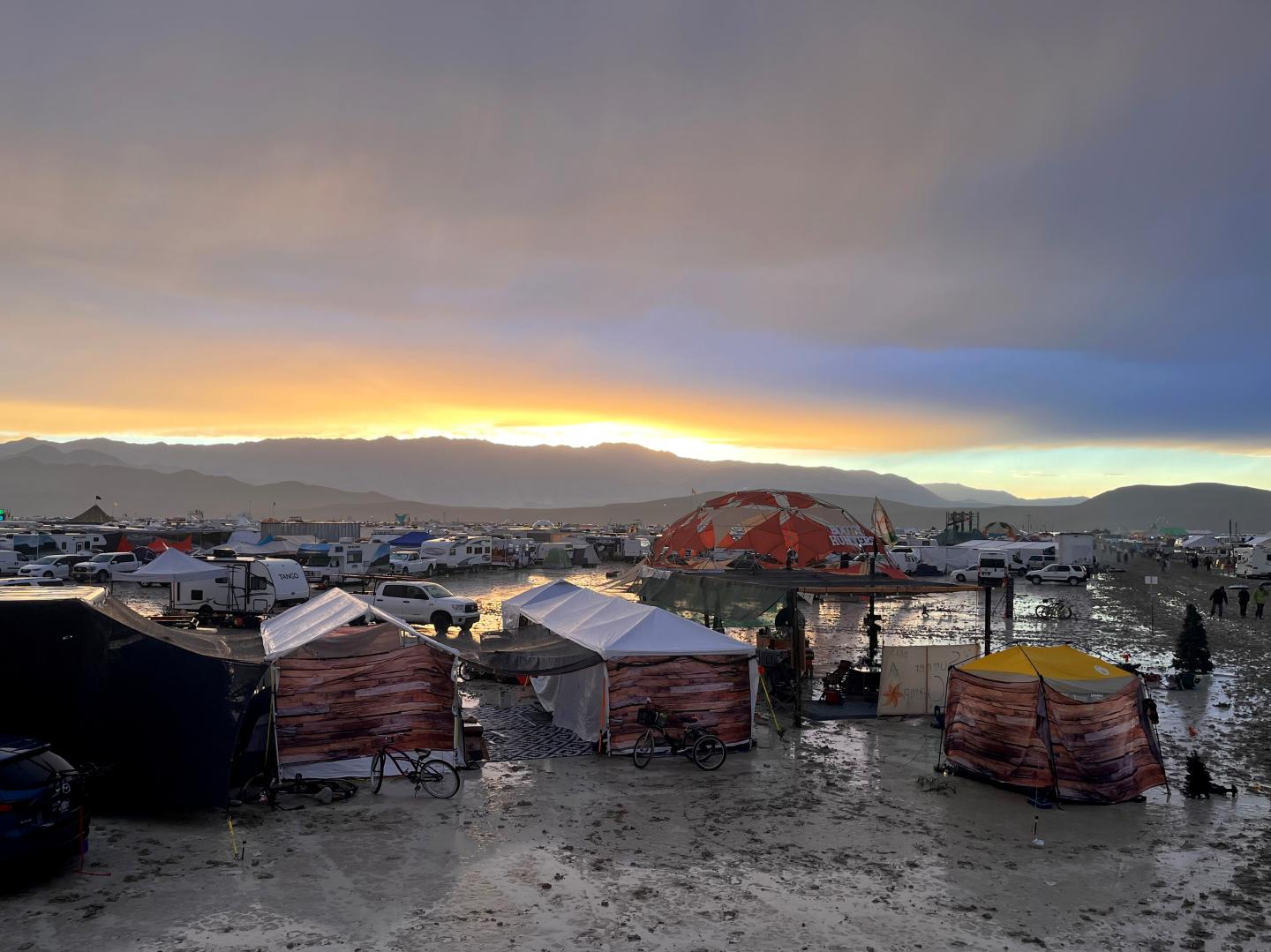 Tents between puddles and mud on the grounds of the Burning Man Festival 2023.