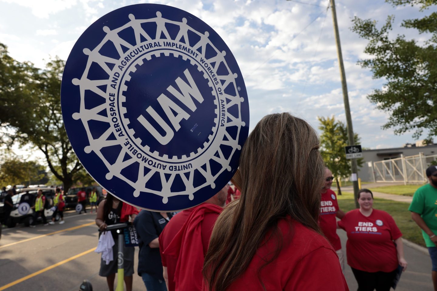 A United Auto Workers (UAW) supporter holds a sign during a Labor Day parade in Detroit.