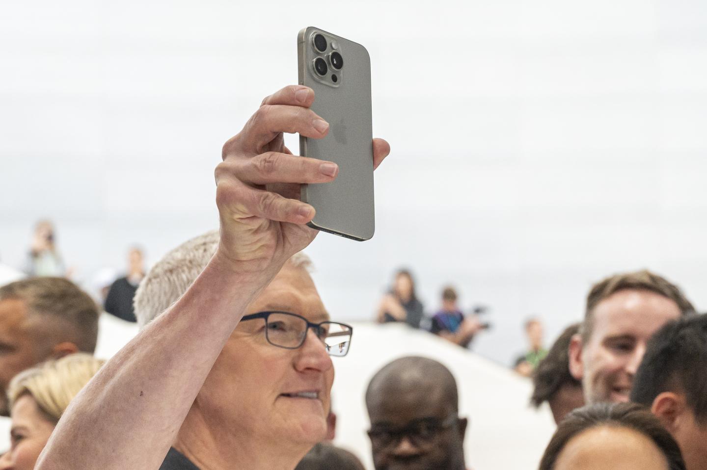 Apple CEO Tim Cook with an iPhone 15 Pro.