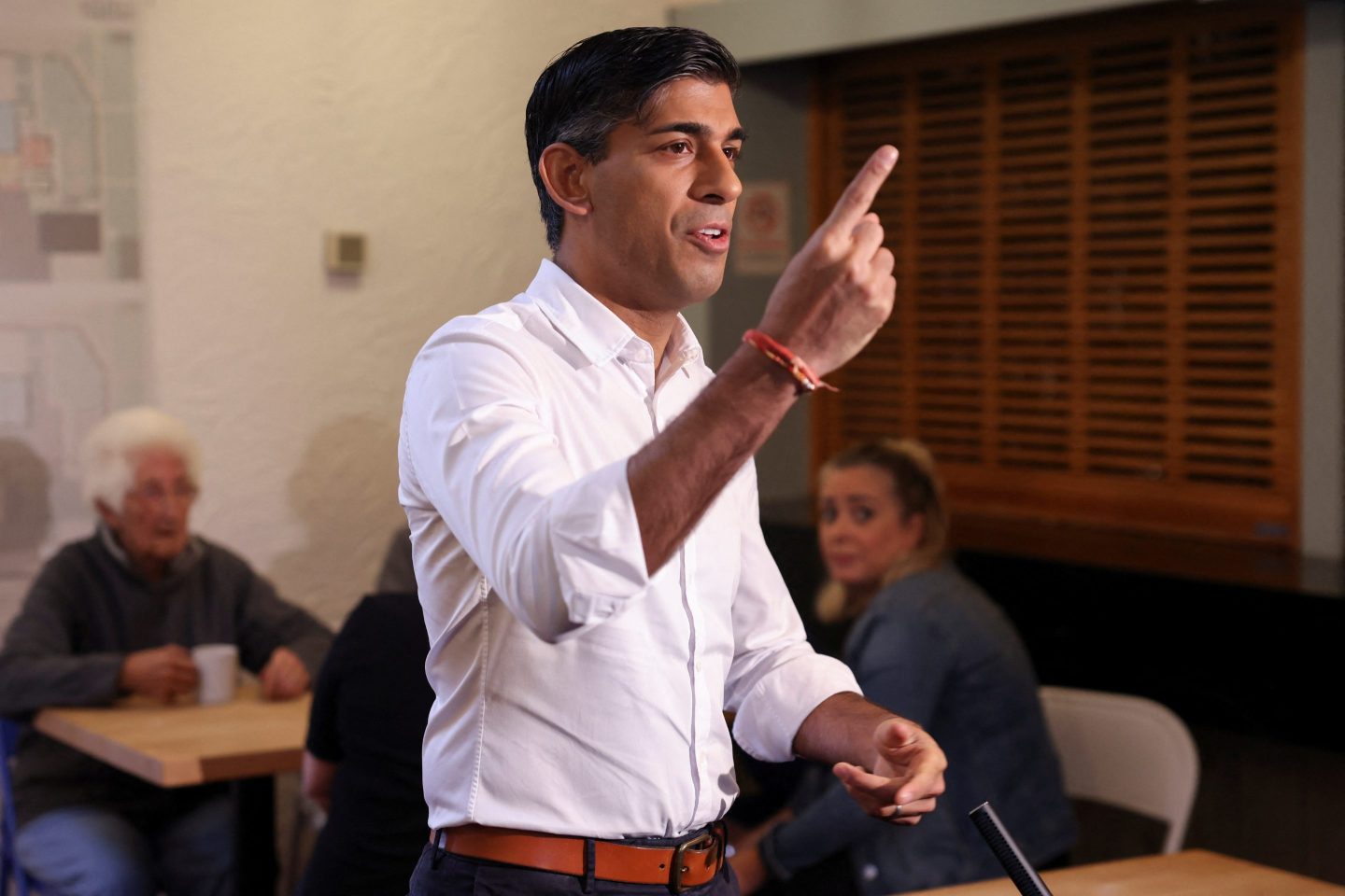 rishi sunak speaking pointing his hand upward