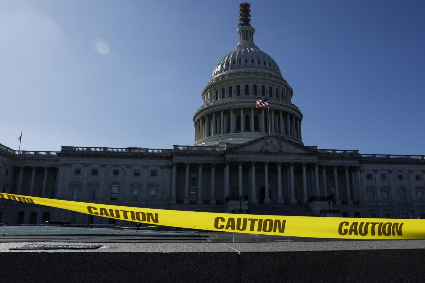 Caution tape blows in the wind on the east front plaza of the U.S. Capitol Building