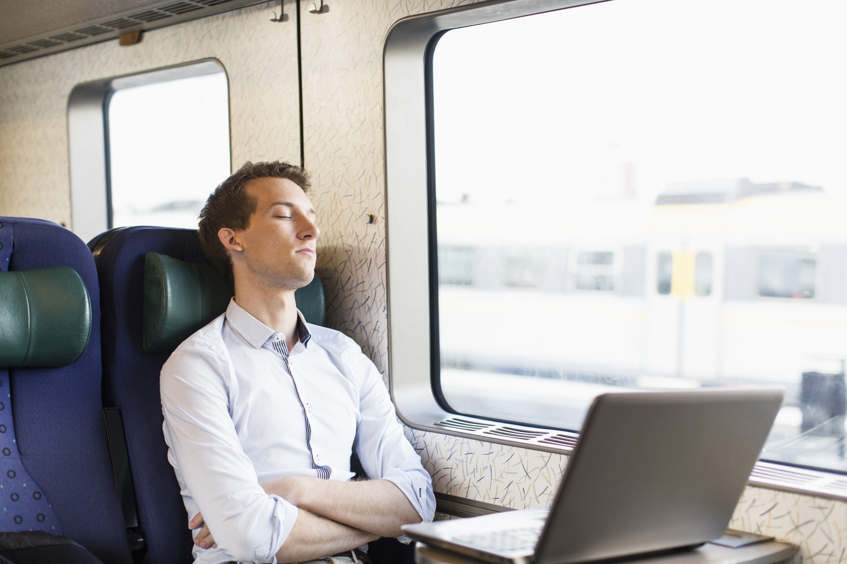 man sleeping on train