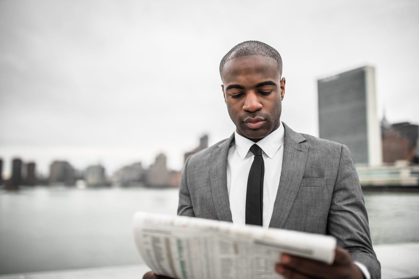 Black man reading newspaper