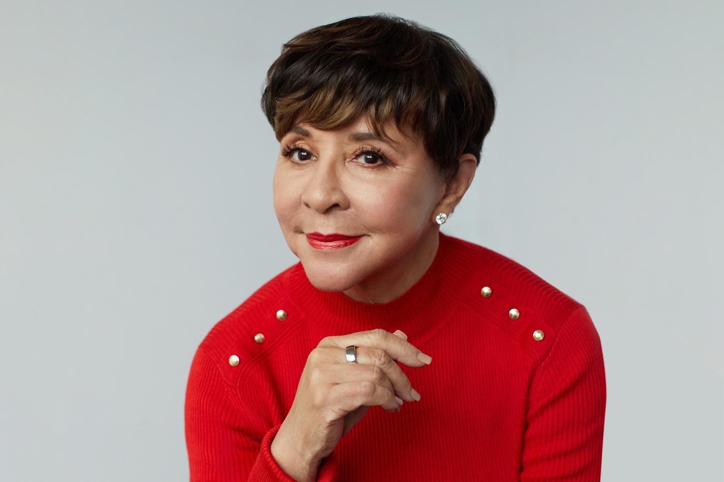Portrait of Shelia Johnson on gray seamless background.