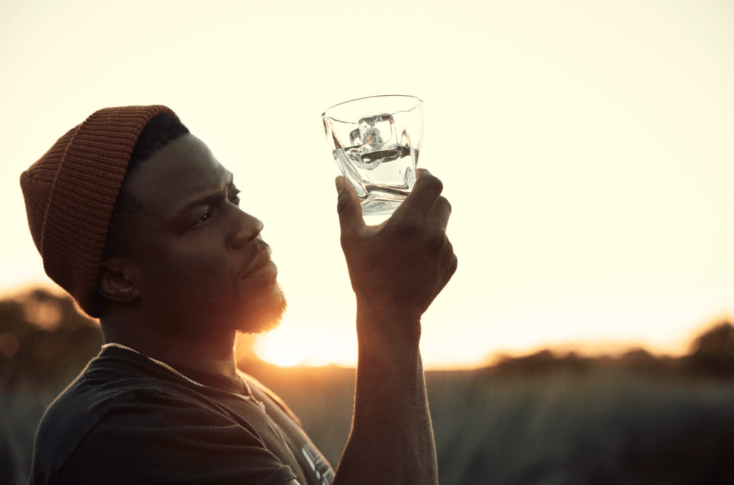 Kevin hart holding glass of tequila