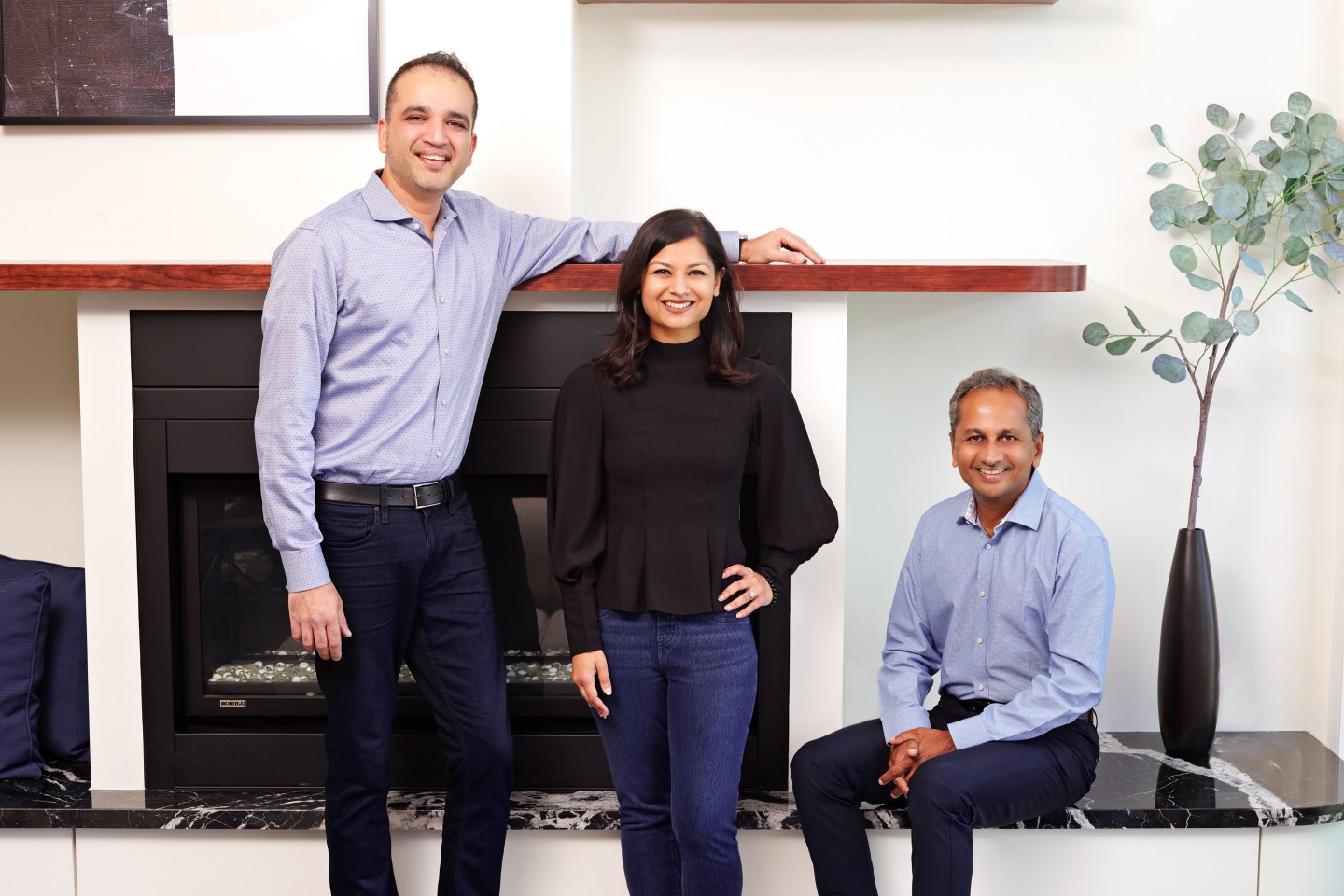3 people in professional clothing posing for a portrait