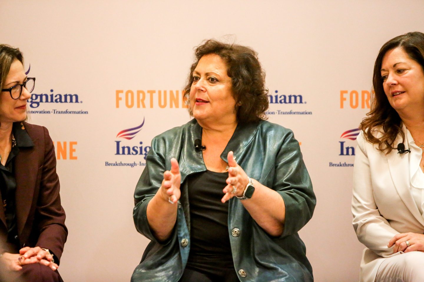 business woman speaking at a panel on stage