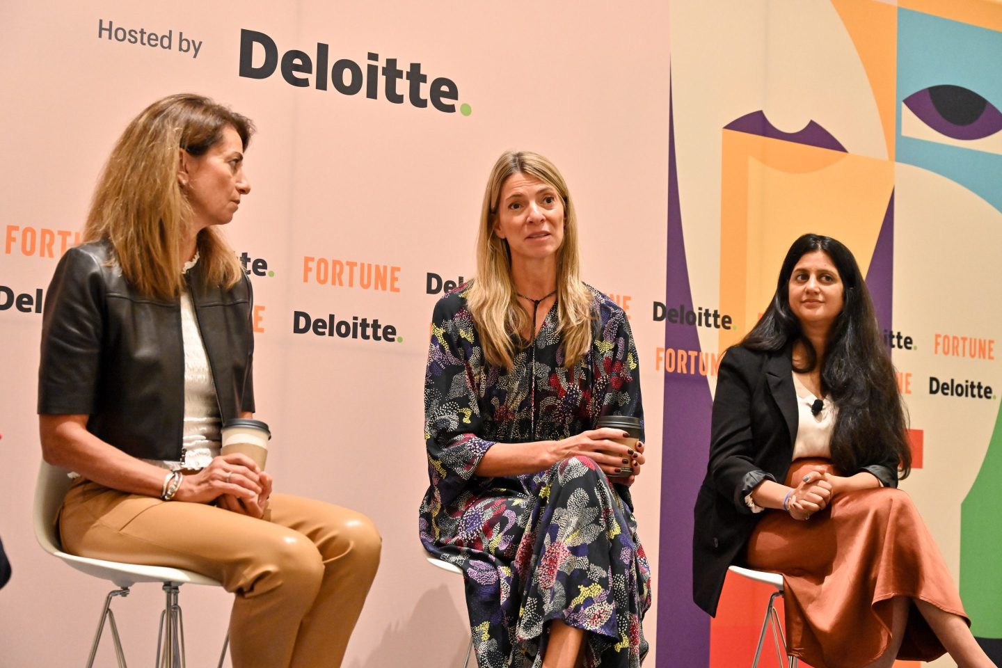 3 businesswomen sitting onstage