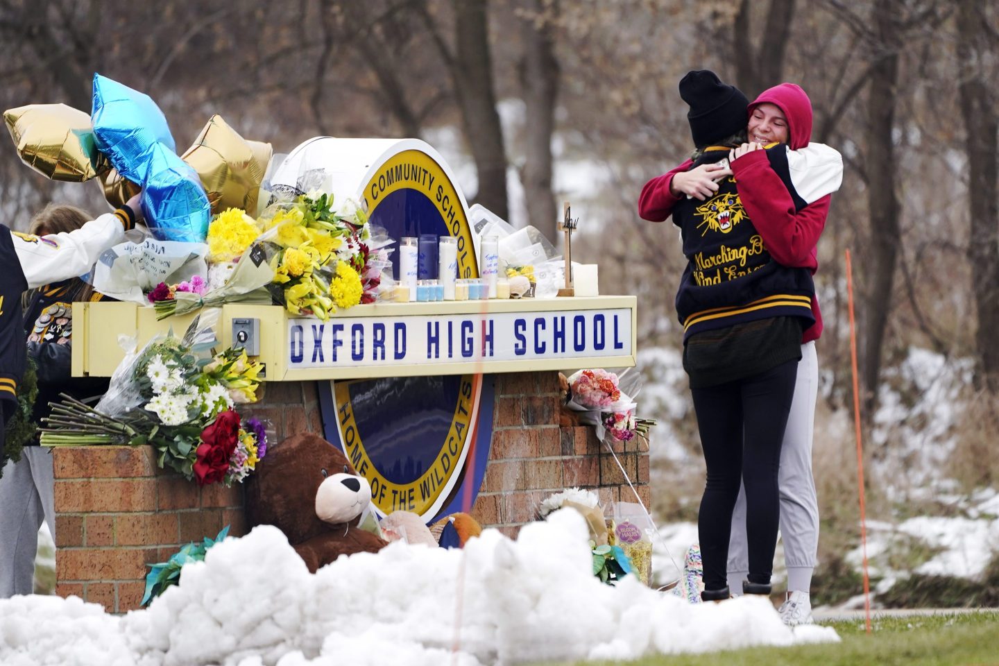 Students hug at a memorial at Oxford High School.