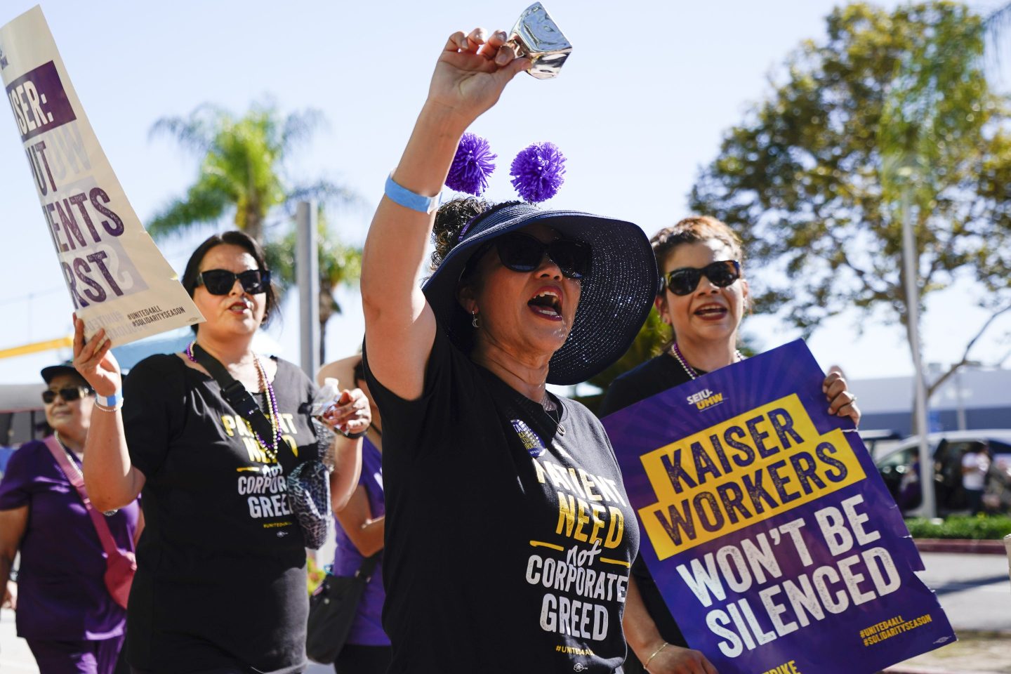 Kaiser Permanente hospital employees picketing with signs and bells.
